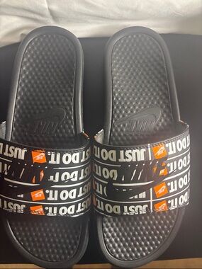 Nike Black Slides with White 'Just Do It' Straps and Orange Logos